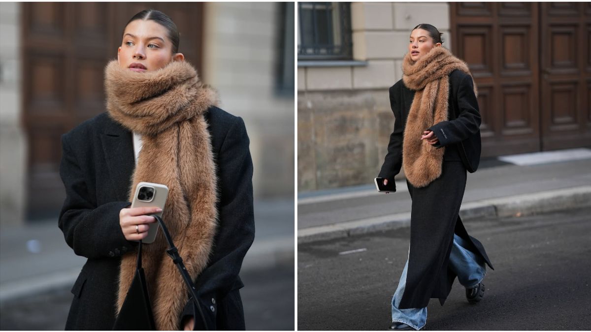 Street style of woman in black coat with oversized tan faux-fur scarf