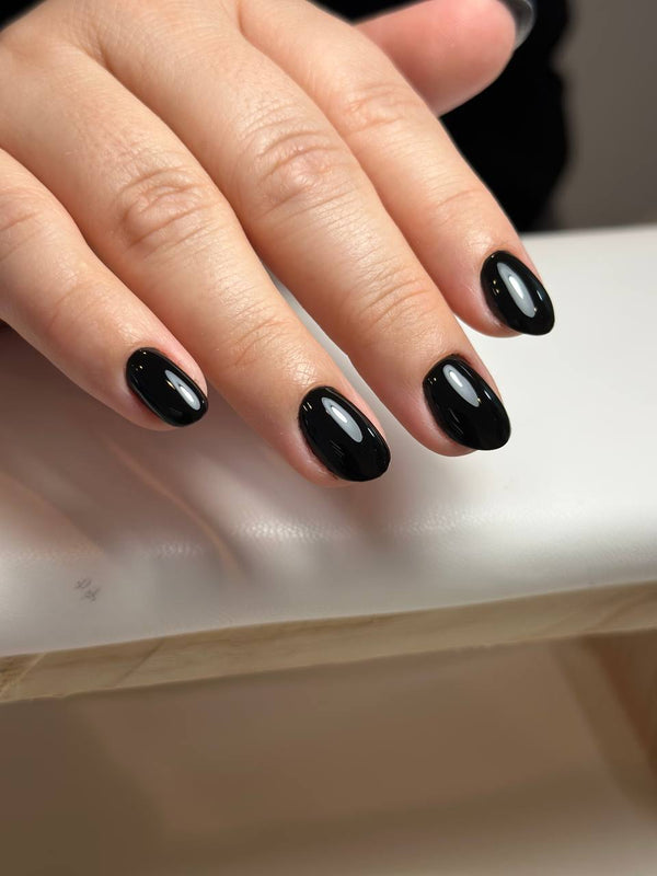 Short almond nails with glossy black gel polish