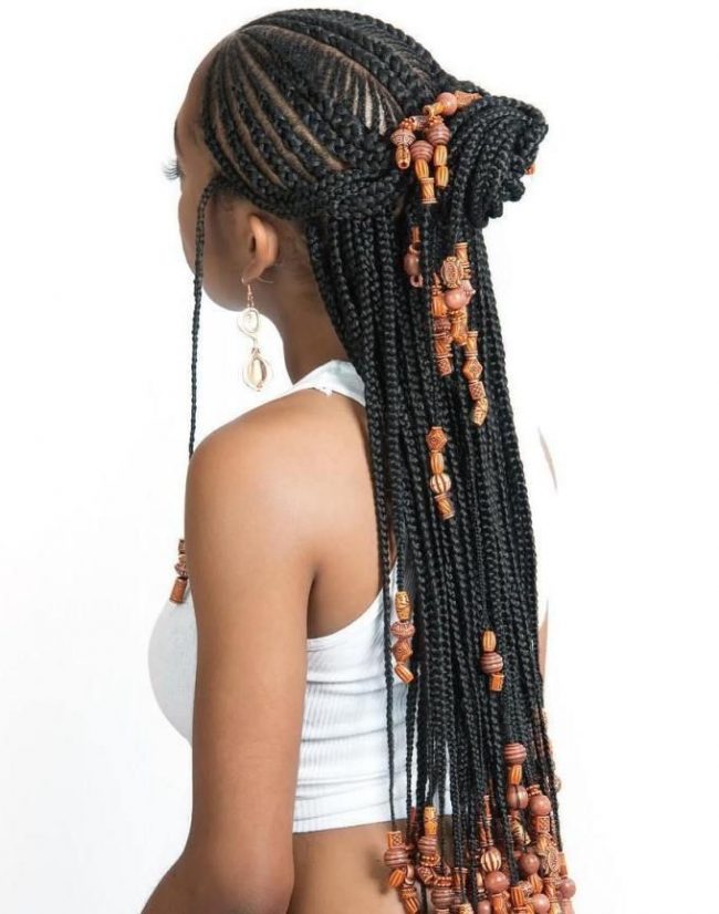 Black tribal braids with cognac wooden beads in a half-up ponytail