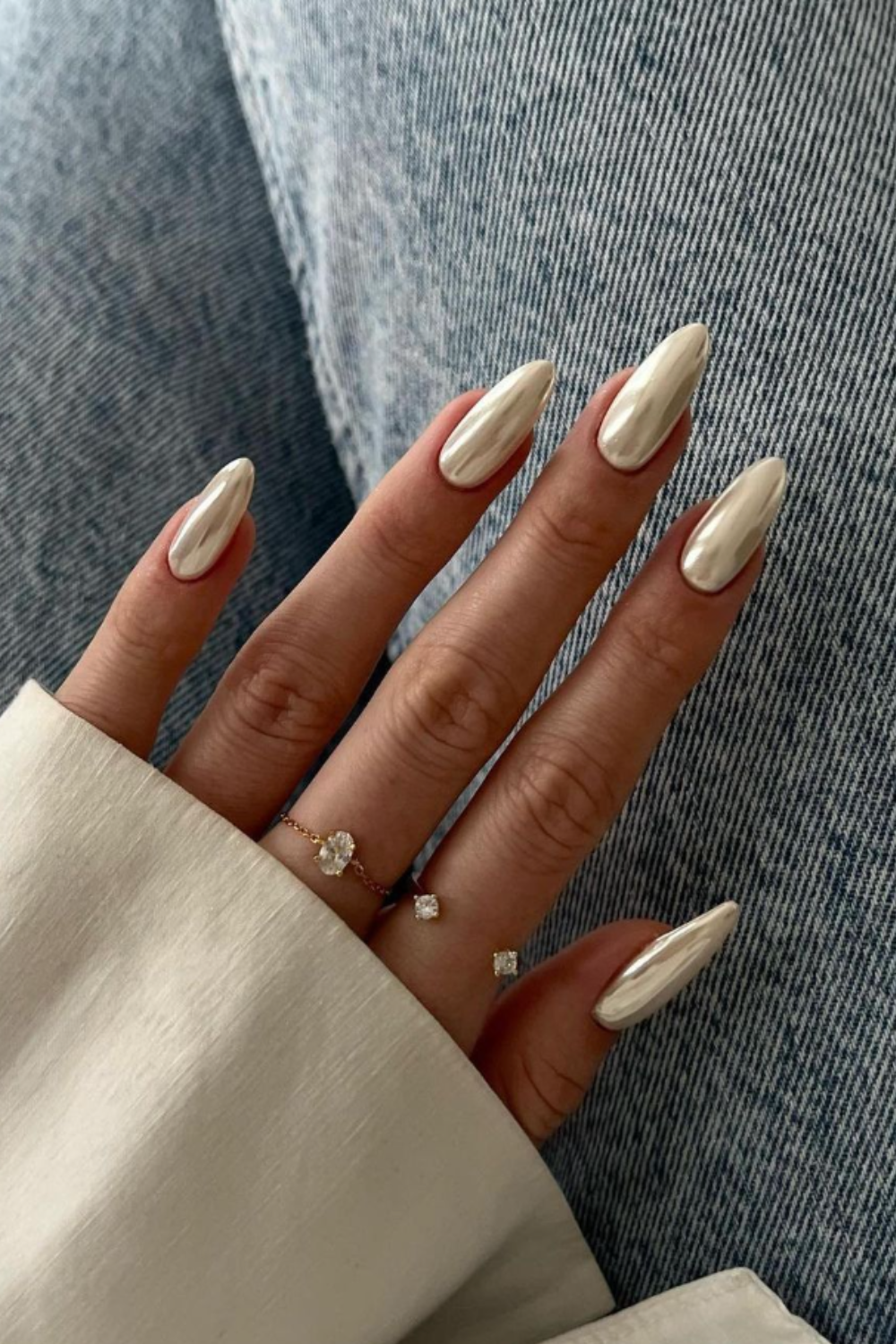 Champagne-gold chrome finish on almond-shaped nails