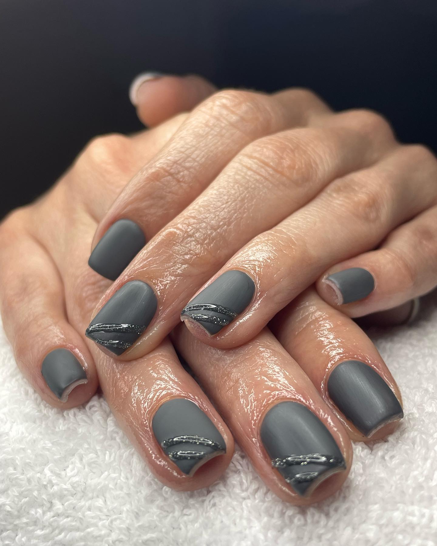 Square nails in matte charcoal grey with thin silver line accents