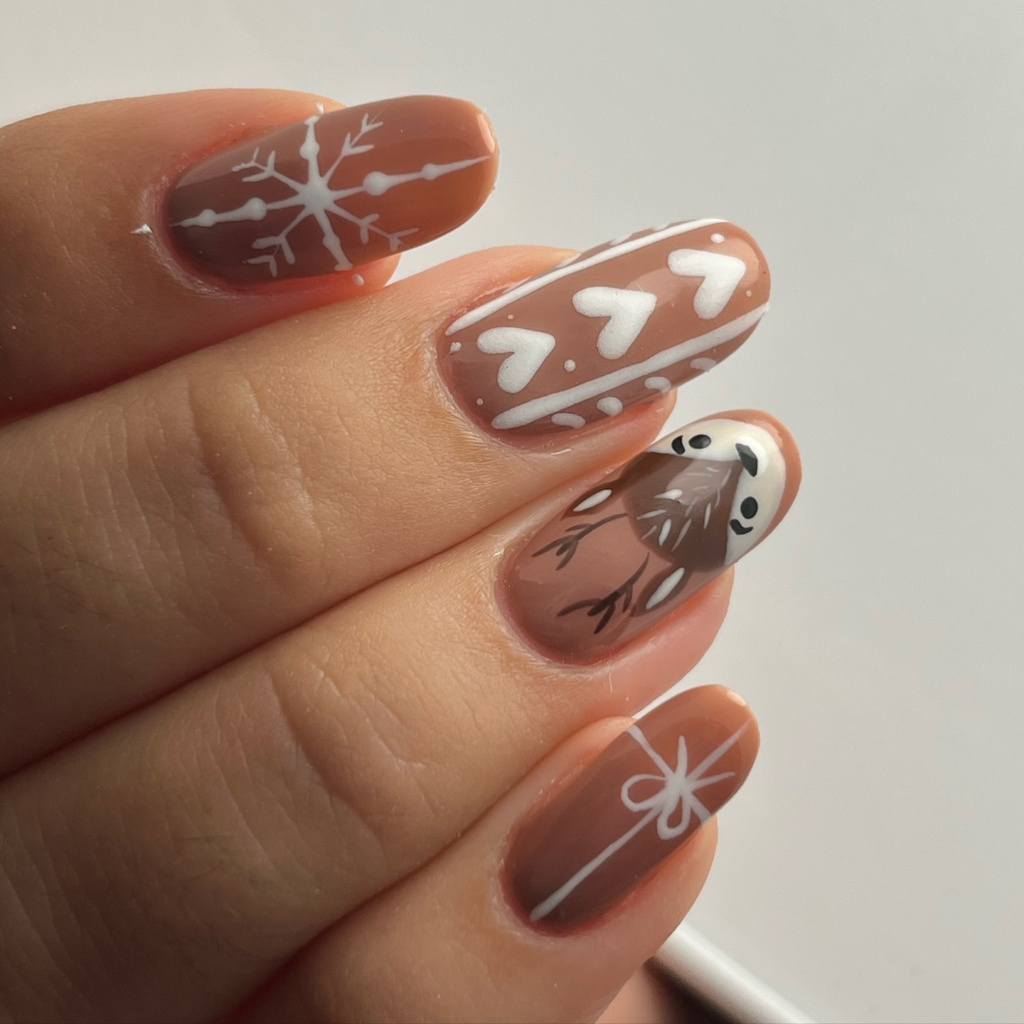 Brown winter nails with white snowflake nail art