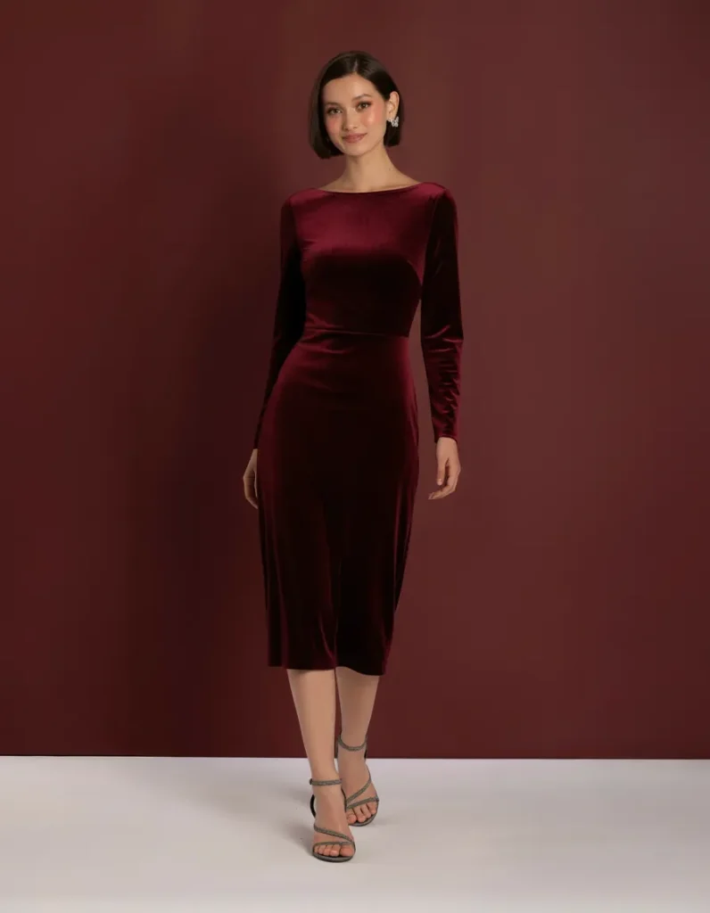 Emerald green velvet slip midi dress styled for a winter formal event
