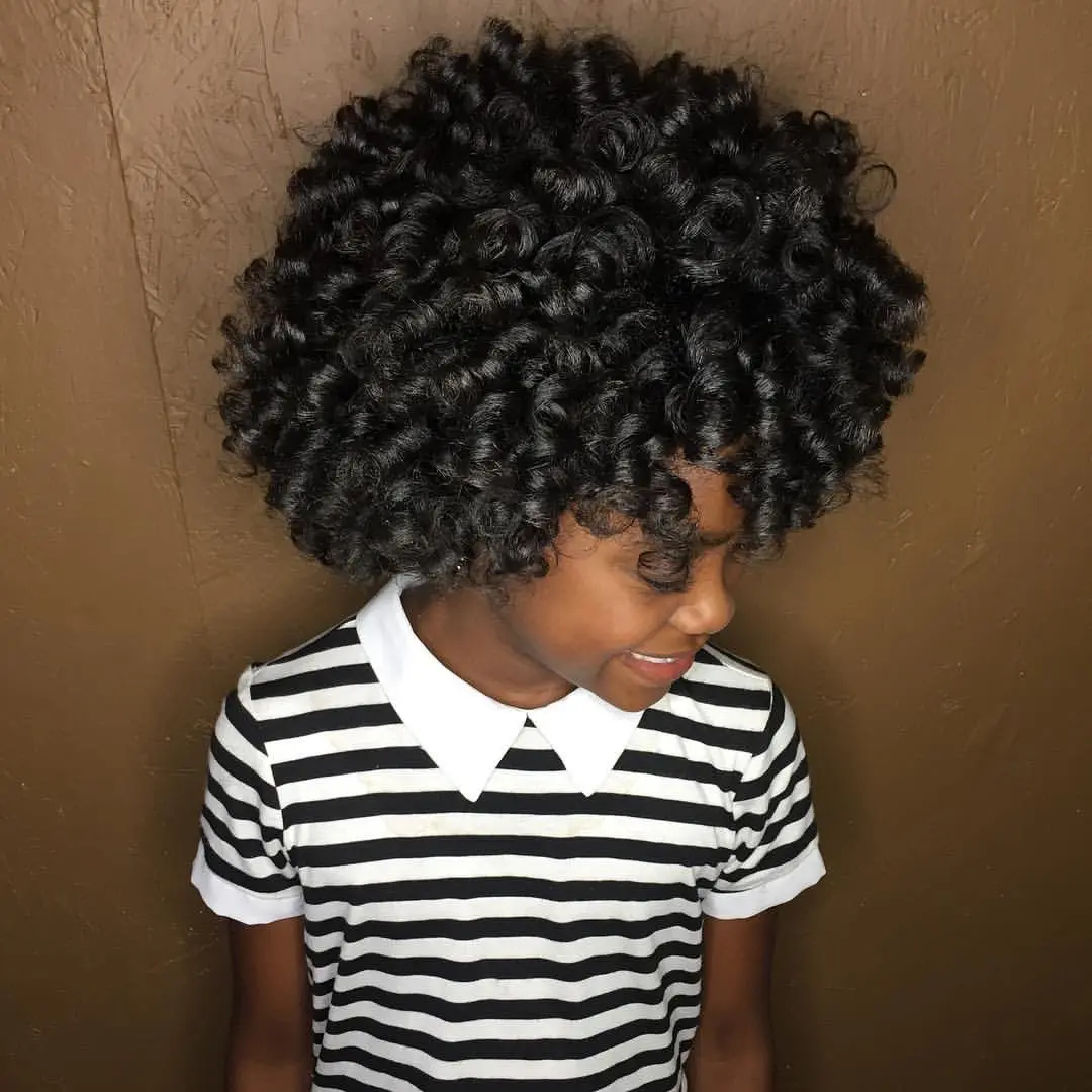 Black child with a tapered haircut and defined coils on top