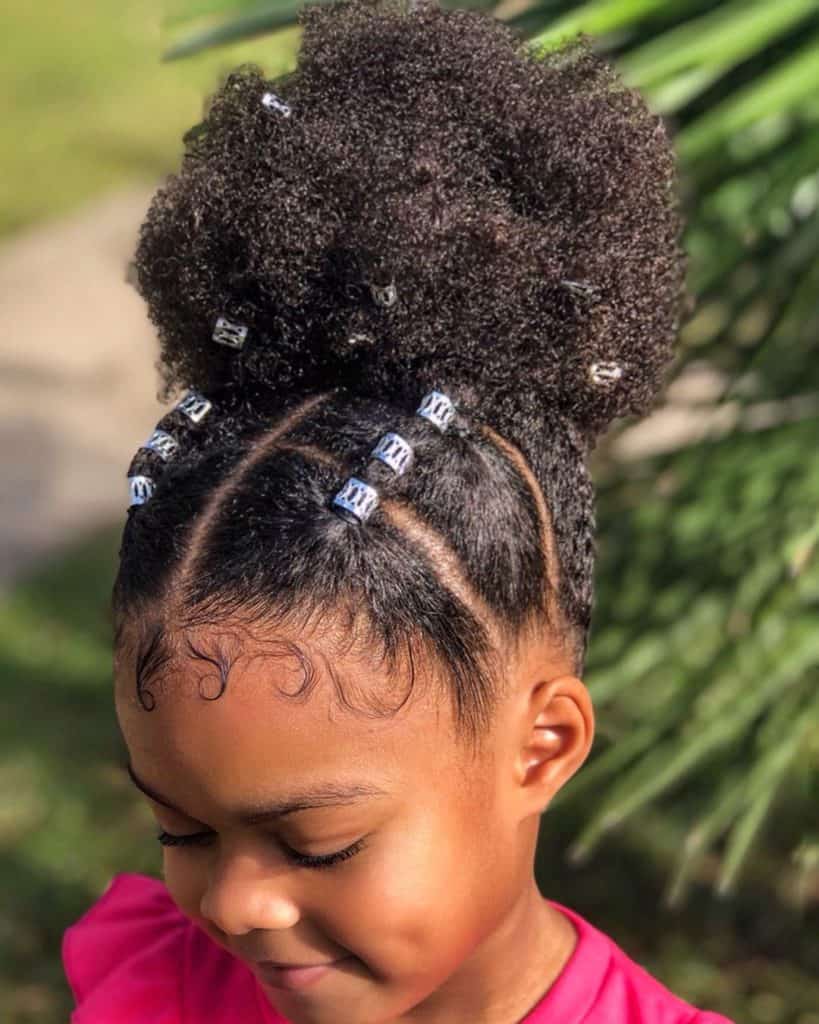 Toddler with high puff pigtails and beaded braid sections