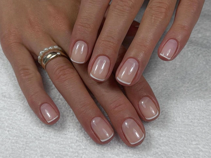 Short nude nails with white French tips