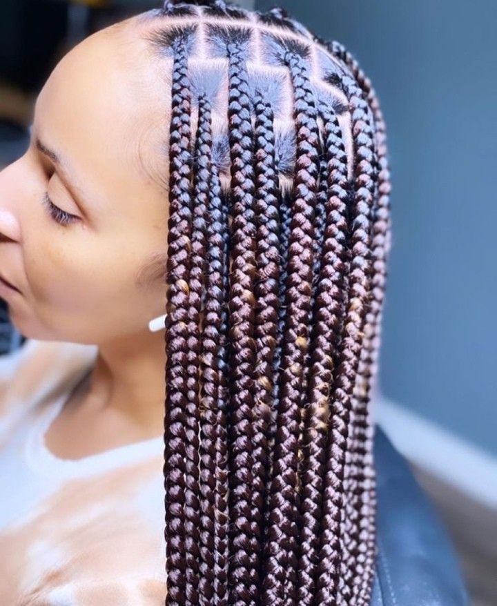 Medium knotless braids with golden-brown highlights