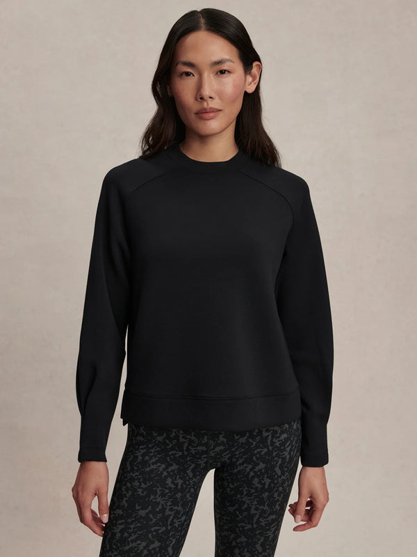 Black sweatshirt paired with dark patterned leggings