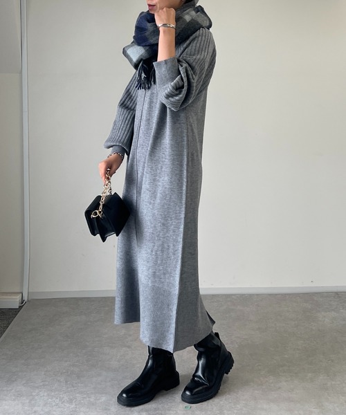 Woman in a grey knit maxi dress with a plaid scarf and black Chelsea boots