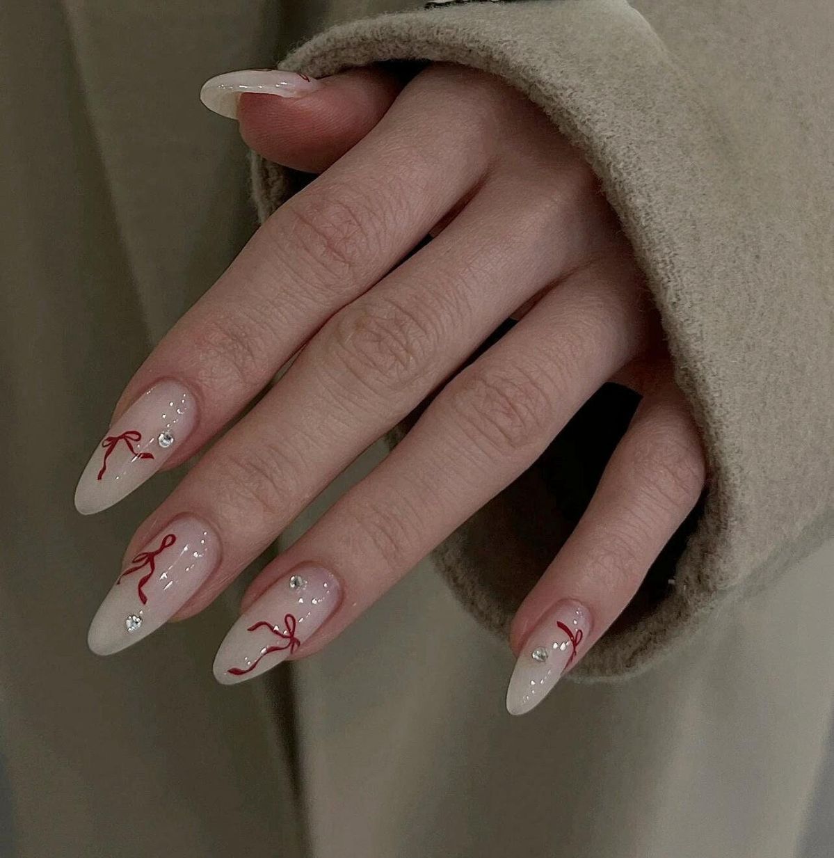 Milky white nails with red bow nail art