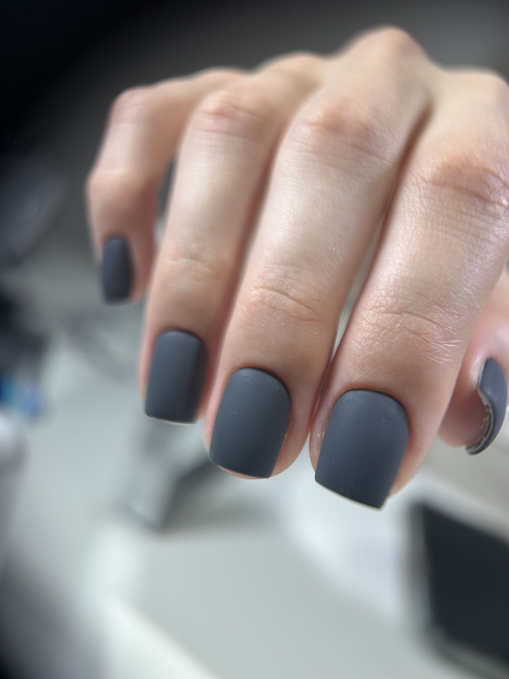Short nails in matte charcoal dark gray polish