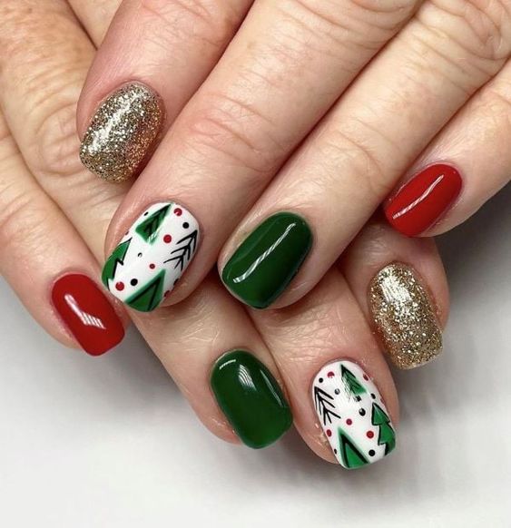 Christmas tree nail art with green trees, red and green solid nails and gold glitter accents