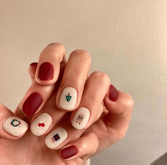 Short matte red and white Christmas nails with tiny tree, snowman and gift art