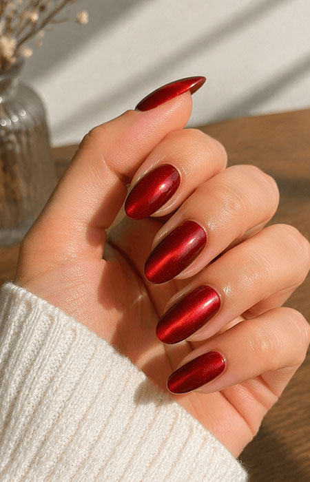 Red cat-eye magnetic shimmer nails on almond nails