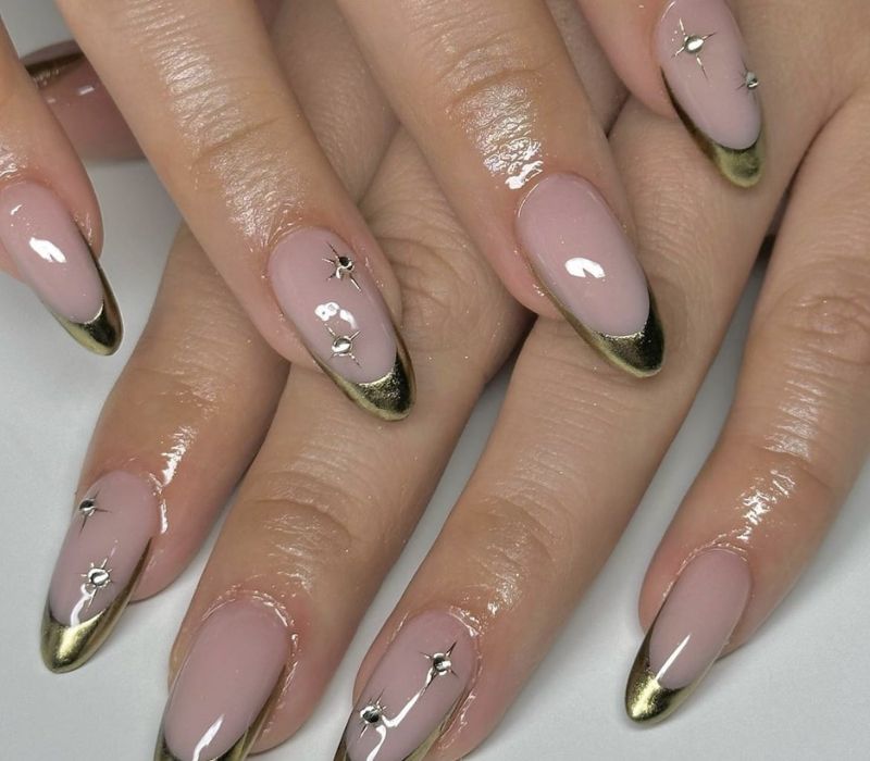 Gold chrome French tip nails on a nude base