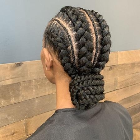 Back view of feed-in cornrows styled into a low braided bun
