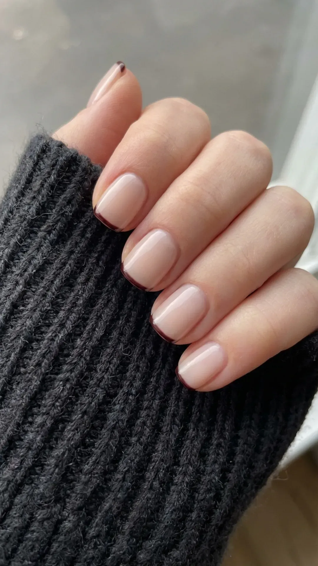 Short nude nails with thin black cherry micro-French tips