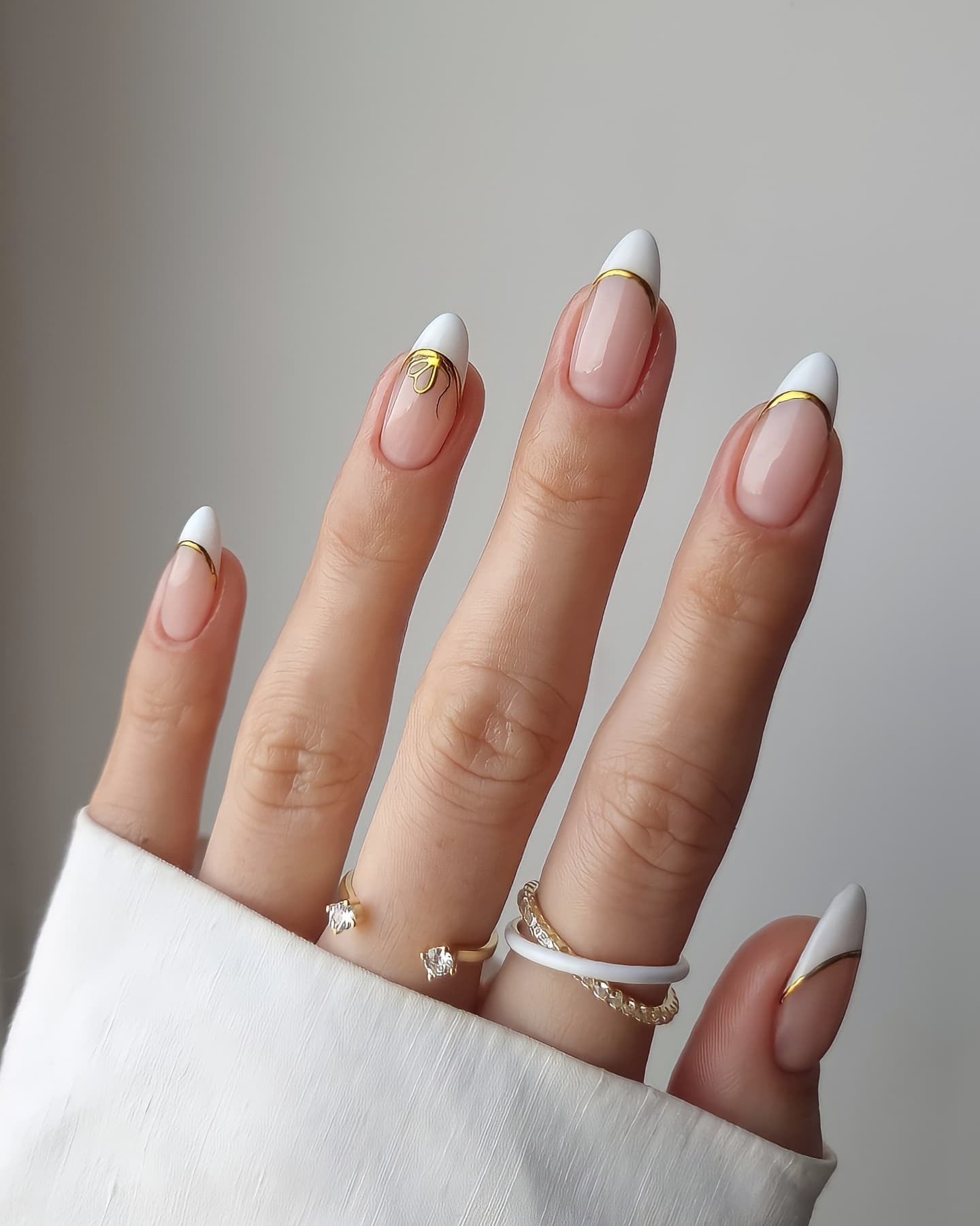 Modern white French nails with gold detail