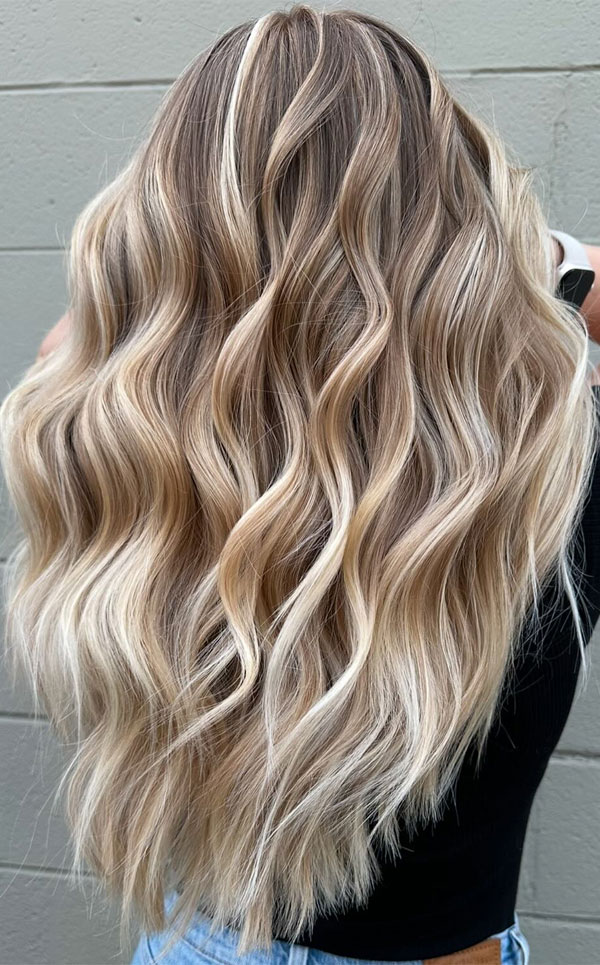 Beige blonde balayage with lush waves on long hair