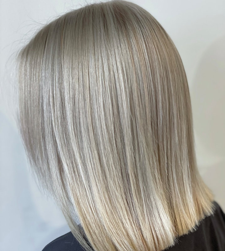 Straight neutral blonde lob with dark ash lowlights, back view