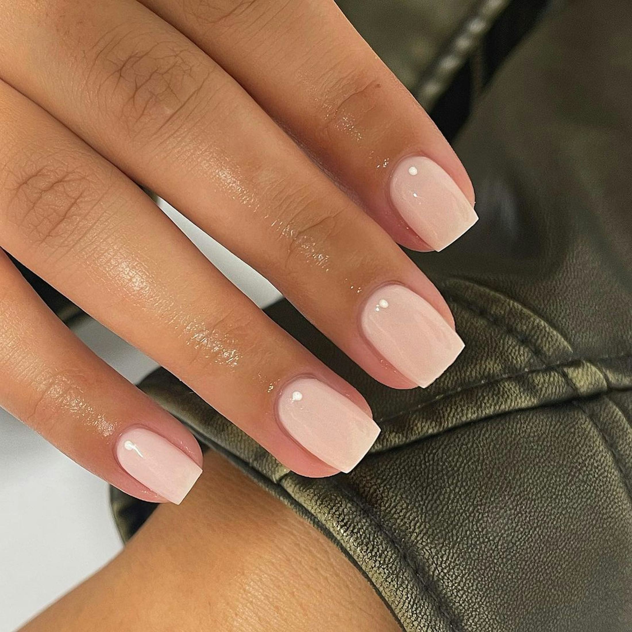 Sheer nude glossy polish on square-shaped nails