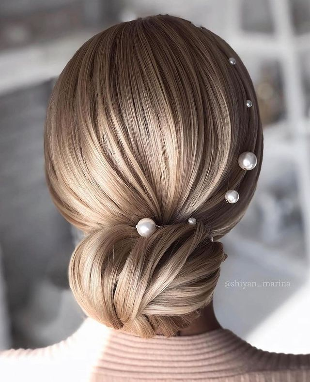 Back view of a low twisted bun decorated with pearl hair pins