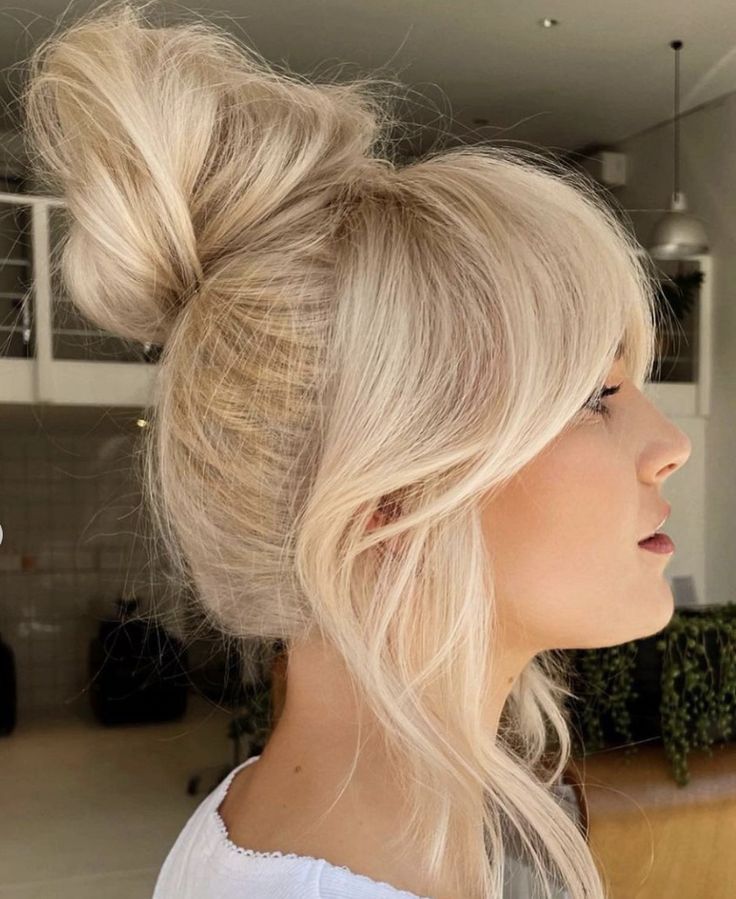 Messy top knot with curtain bangs