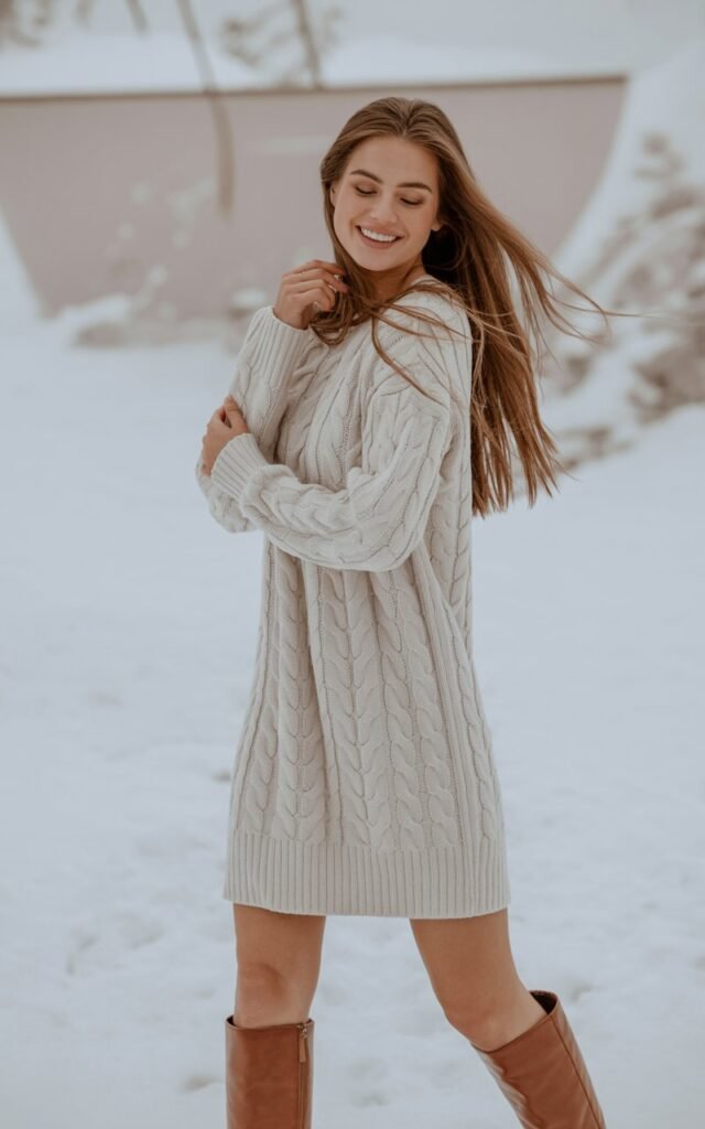Woman wearing a knit dress with knee-high boots