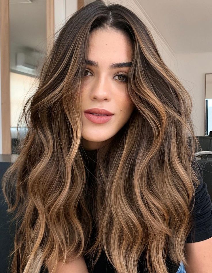 Woman with dimensional copper and honey face-framing balayage highlights