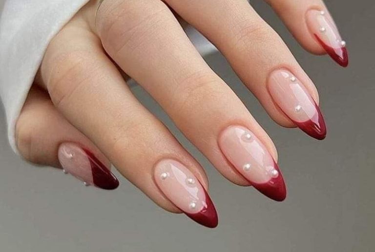 Cherry-red French tip nails decorated with small pearls