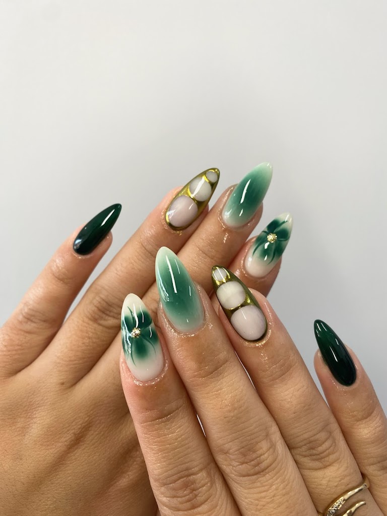 Long almond nails with green watercolor fade, gold chrome frames and deep green solids