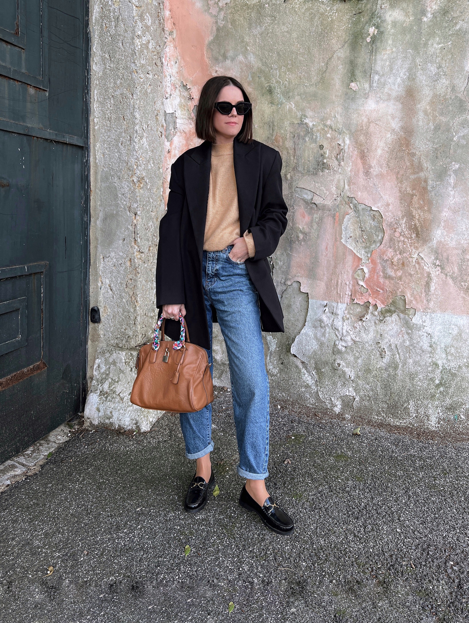 Camel blazer styled with dark skinny jeans and loafers