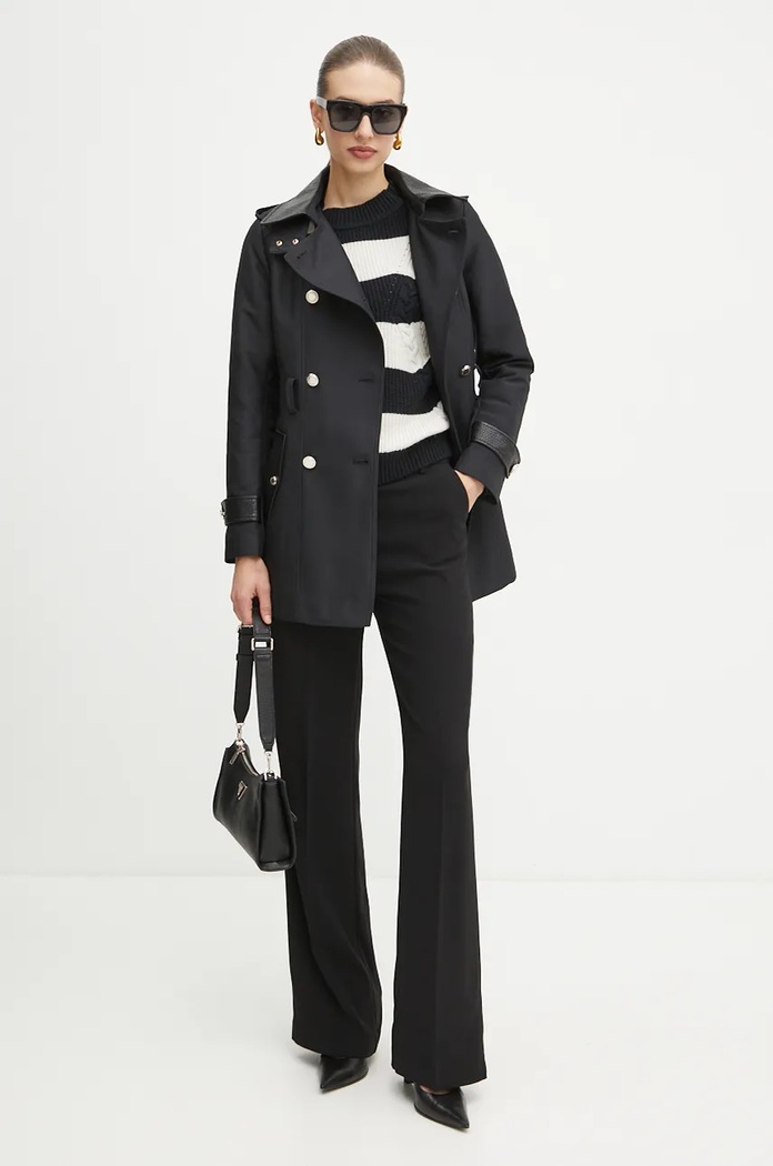 Black patent trench coat styled with a striped knit top