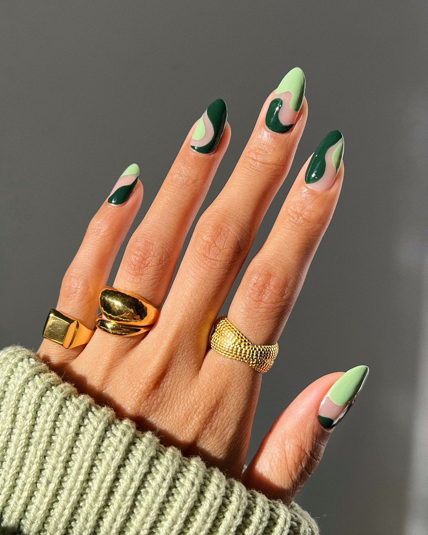 Abstract green nail art with negative space