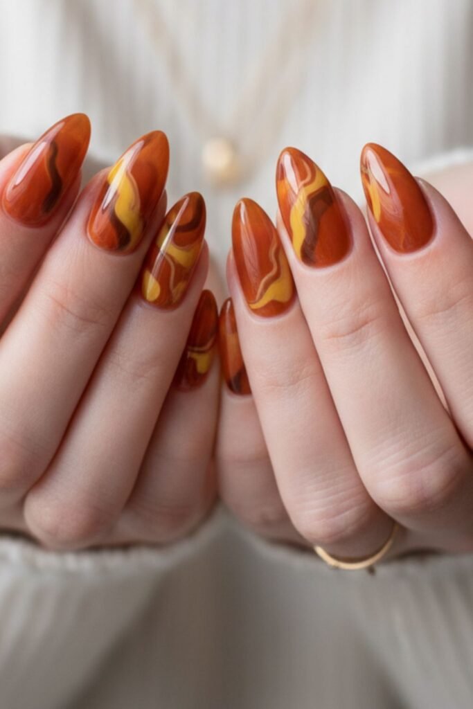 Almond nails with golden amber marble nail art