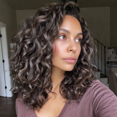 Curly hair in natural ash brown color