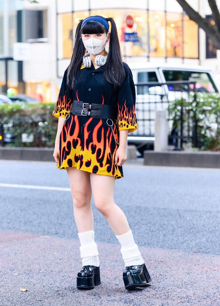 White slouchy leg warmers with an orange flame print black shirt dress and chunky black platform Mary Janes