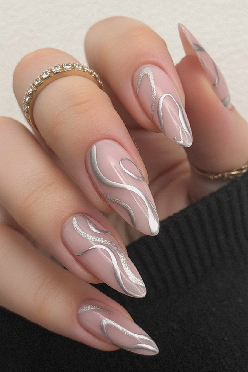 Sheer nude almond nails with silver chrome swirl line art