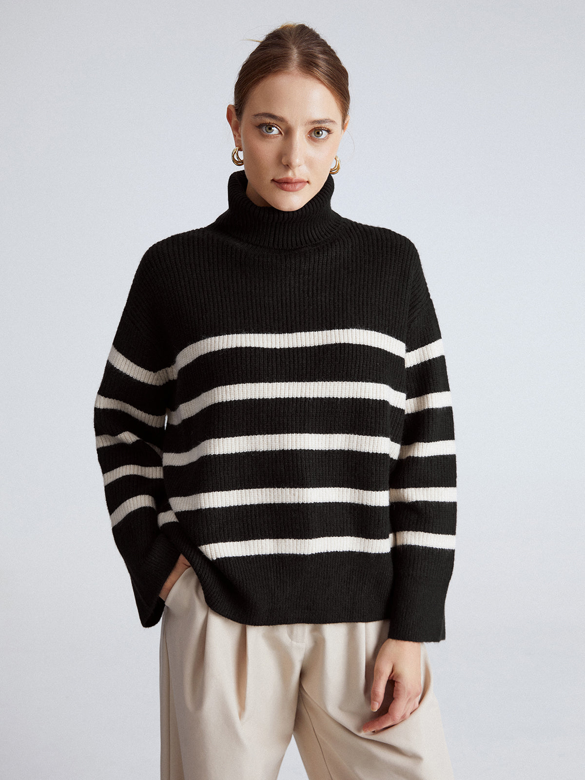 Woman wearing a dressed-up turtleneck knitwear look for winter evening