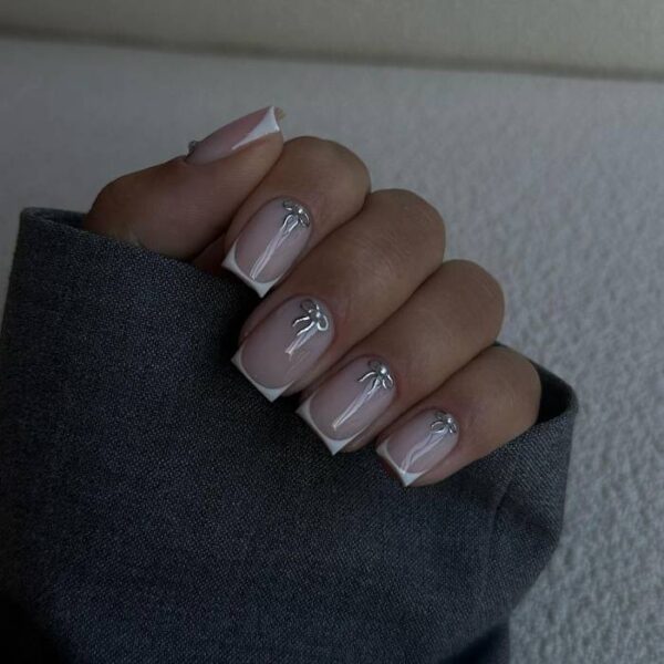 Builder-gel nails with white french tips and a fine ribbon line along the smile line
