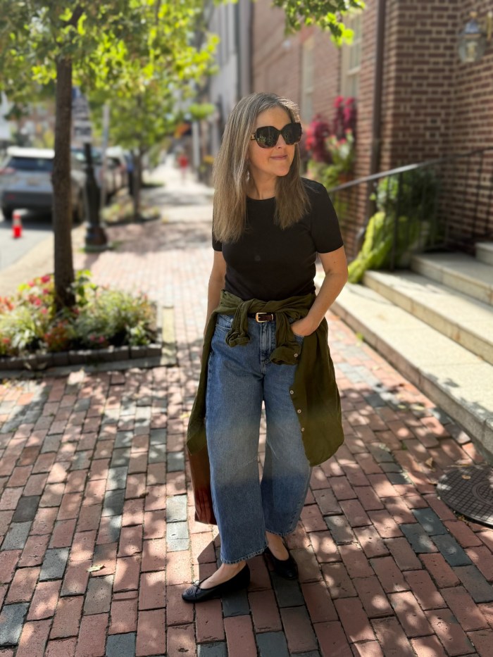 Fitted tee with linen button-up shirt tied at the waist, barrel-leg jeans and ballet flats