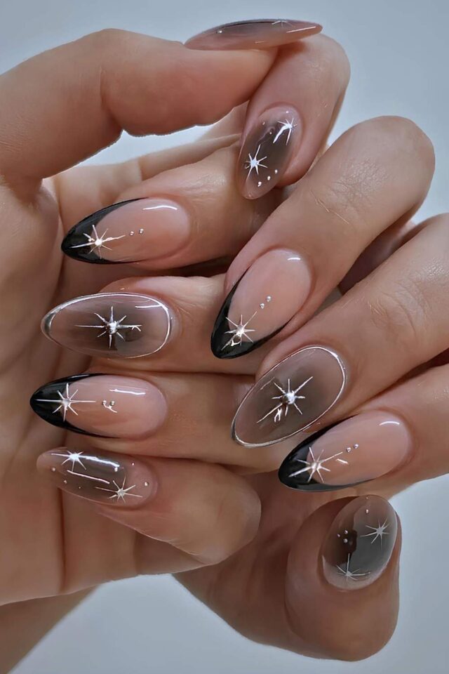 Black French tip nails with silver starbursts