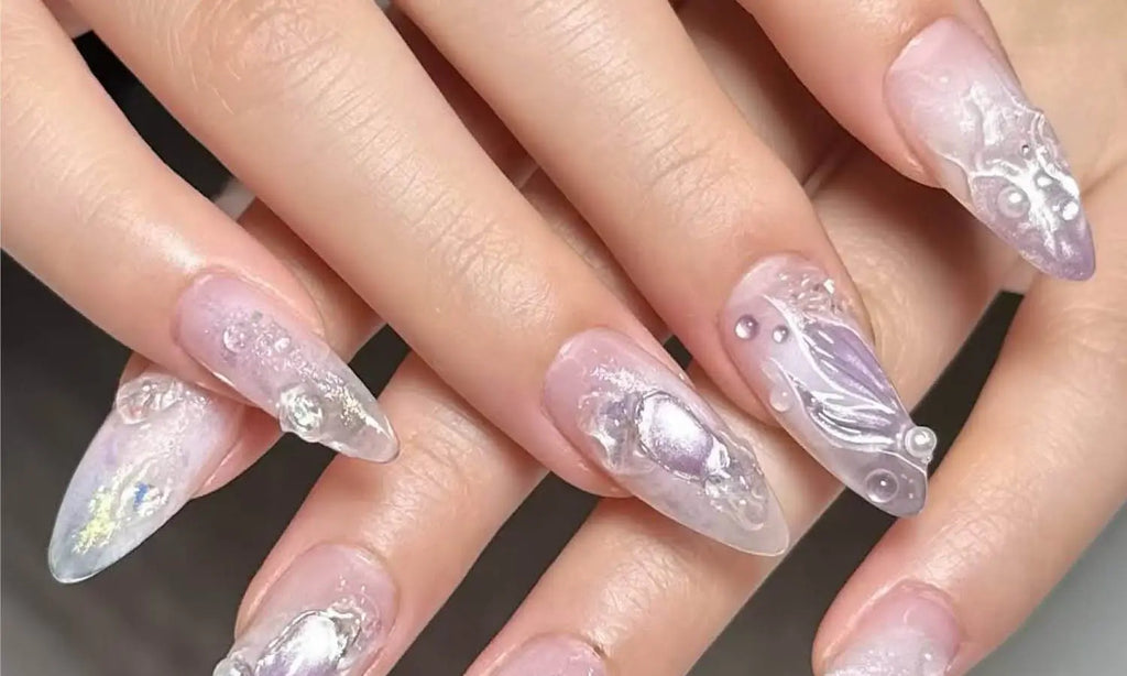 Almond acrylic nails in milky white with 3D pearl and gemstone accents