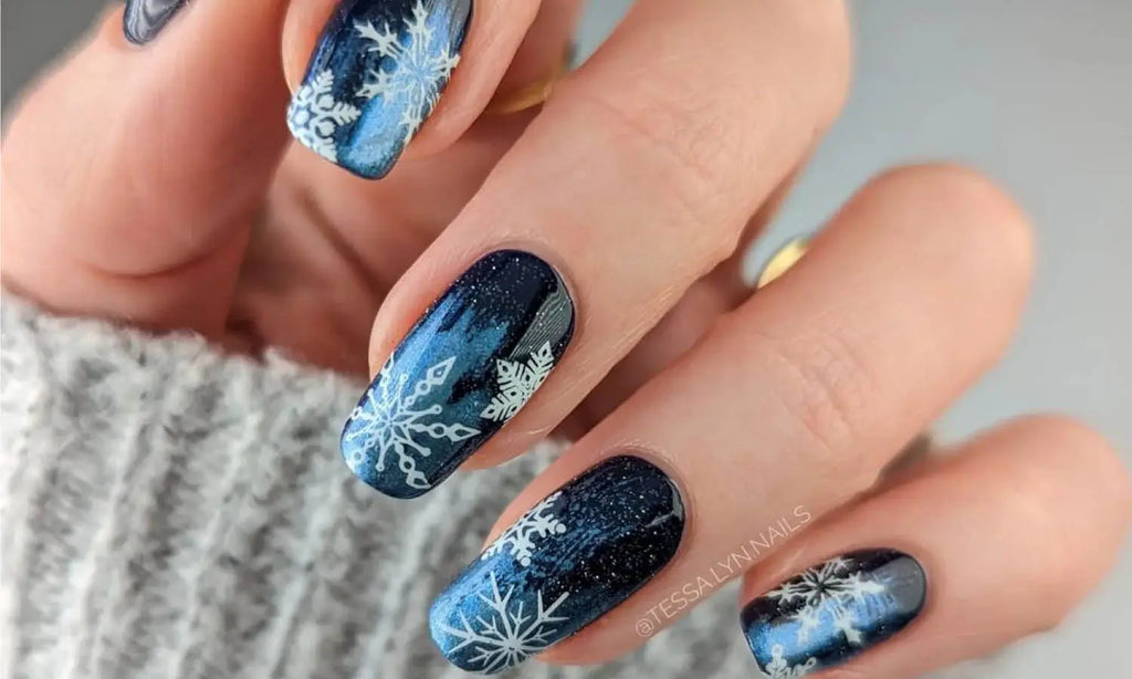 Short almond navy nails with white snowflake nail art