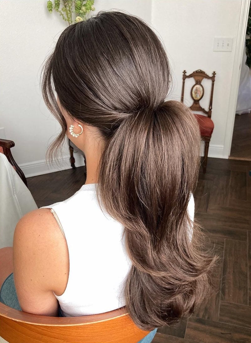A voluminous bouncy blowout ponytail on brunette hair