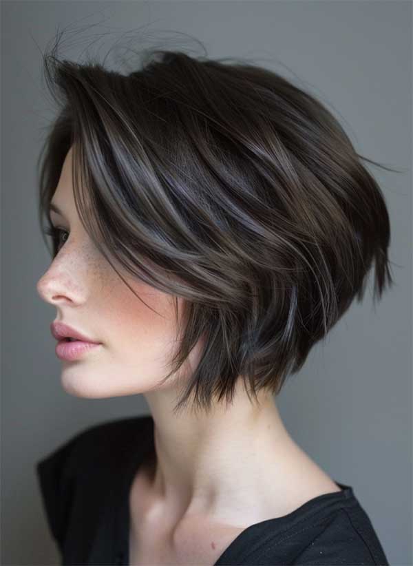 Layered brunette bob styled in a bouncy blowout with volume
