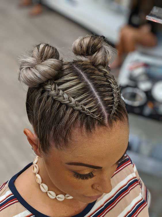 Top view of double dutch braids styled into two buns