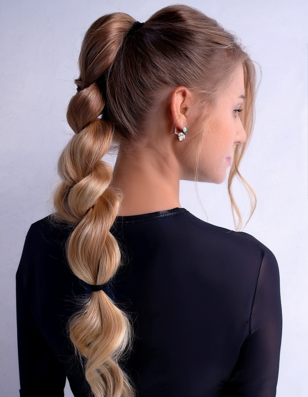 High ponytail styled into a bubble braid