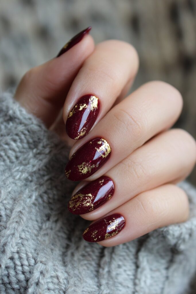 Burgundy with Gold Leaf: wine-colored nails with gold leaf accents