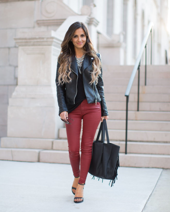 Woman wearing burgundy leather pants in a fall outfit